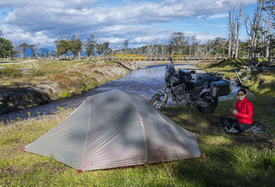 Portrait of woman camping next to ruta j, tierra del fuego