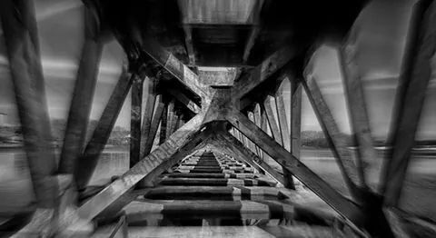 built structure, architecture, bridge - man made structure, connection, indoors, transportation, low angle view, railing, diminishing perspective, the way forward, engineering, bridge, no people, footbridge, long, vanishing point, rail transportation, steps, architectural column, metal