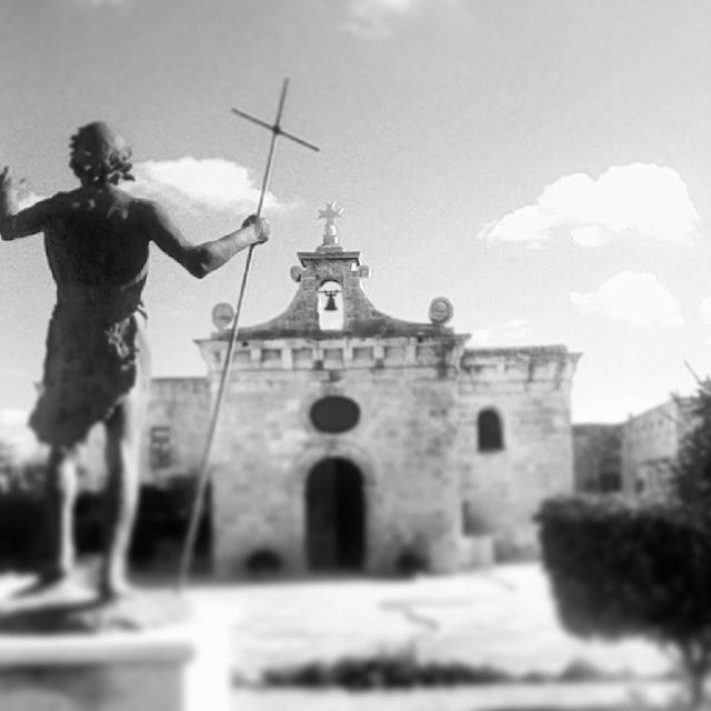 architecture, building exterior, built structure, sky, religion, statue, human representation, spirituality, place of worship, sculpture, history, low angle view, church, day, outdoors, clear sky