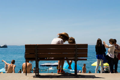 Rear view of woman relaxing on beach