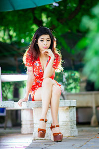 Portrait of a young woman sitting outdoors