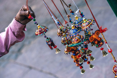 Close-up of hand holding multi colored decoration