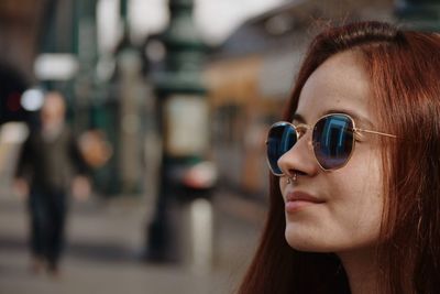 Close-up portrait of young woman wearing sunglasses