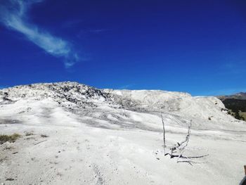 Scenic view of snow covered mountains against sky