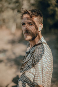 Portrait of man looking away outdoors