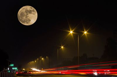 Light trails against clear sky at night