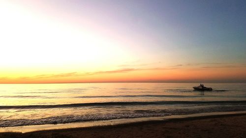 Scenic view of beach against sky during sunset