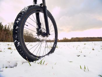 Cyclist on mountain bike on snowy hill. landscape with fresh snow. extreme sports and biking concept