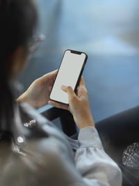 Midsection of woman using mobile phone