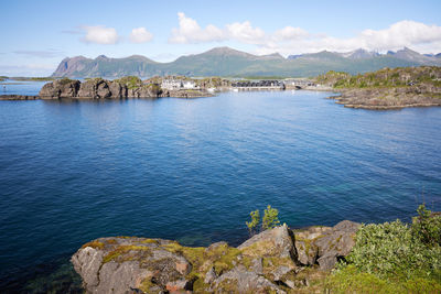 Scenic view of sea and mountains against sky