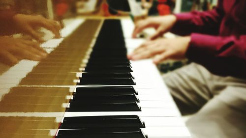 Close-up of hands playing piano