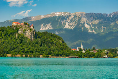 Scenic view of sea and mountains against sky