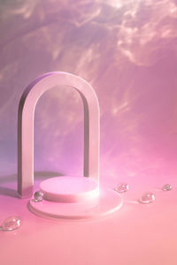 Empty scene with podium and arch on pastel background