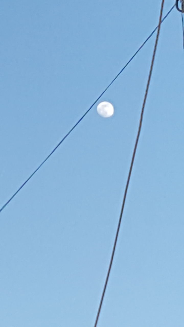 low angle view, power line, clear sky, electricity, cable, connection, copy space, power supply, street light, electricity pylon, lighting equipment, blue, power cable, technology, sky, fuel and power generation, moon, pole, outdoors, no people