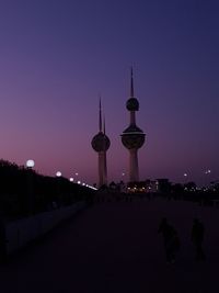 View of communications tower and buildings at night