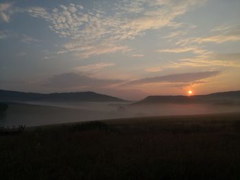 Scenic view of field against sky during sunset