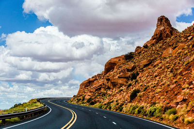 Road amidst mountains against sky