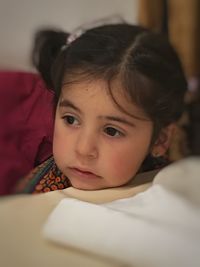 Close-up portrait of cute girl at home