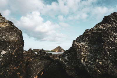 Low angle view of rock formation against sky