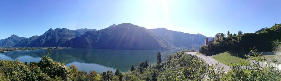 Panoramic view of lake and mountains against clear blue sky