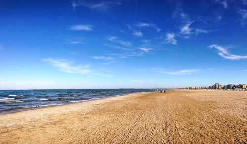 Scenic view of beach against cloudy sky