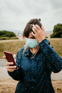 Midsection of woman using mobile phone