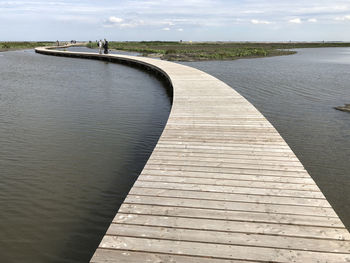 View of pier over river against sky