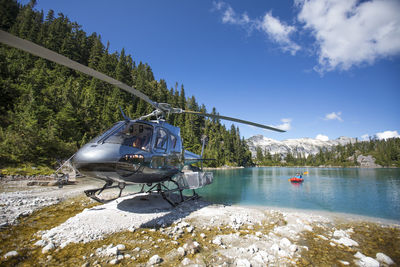 Active man paddling next to helicopter during adventure tour.