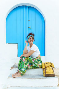 Vertical view of woman with backpack on holidays. woman on stairs on spanish travel destination.