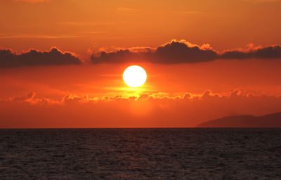 Scenic view of sea against romantic sky at sunset