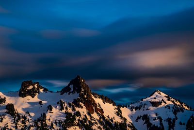 Scenic view of snowcapped mountains against sky during sunset