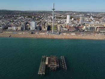 High angle view of buildings by sea against sky