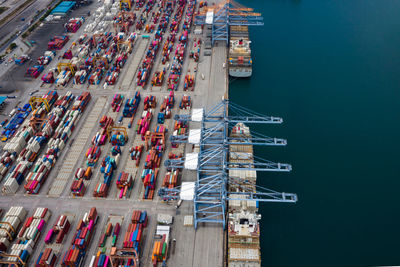 High angle view of commercial dock by pier against blue sky