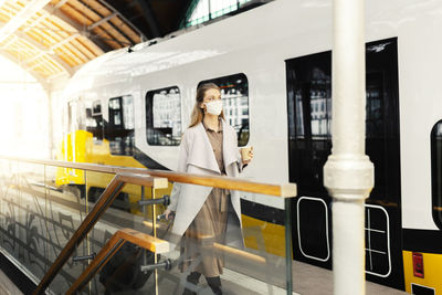 Woman standing on train at railroad station