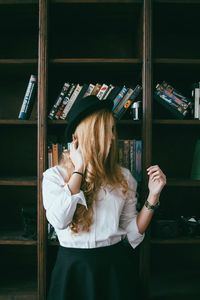 Portrait of young woman sitting on wall