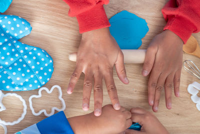 Hands of children playing with toys on table