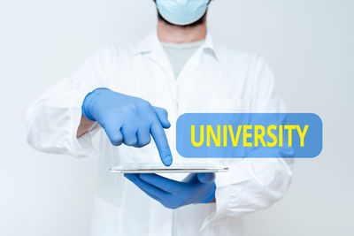 Midsection of man with text standing against white background