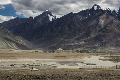 Scenic view of mountains against cloudy sky