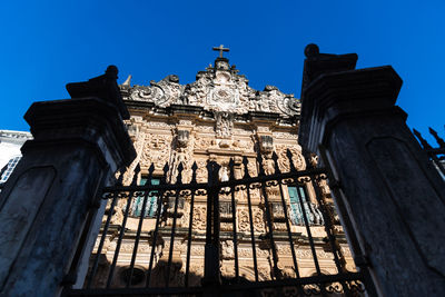 Low angle view of historical building against clear blue sky