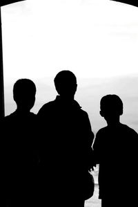 Silhouette people standing against white background