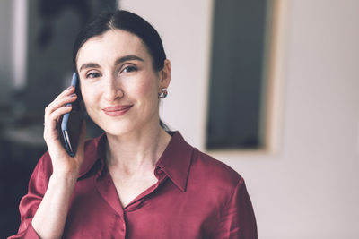 Portrait of mid adult woman using mobile phone