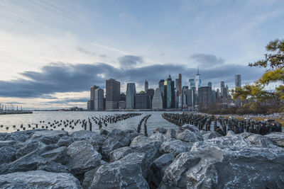 Panoramic view of sea and buildings against sky