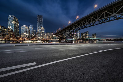 View of illuminated bridge and buildings at night
