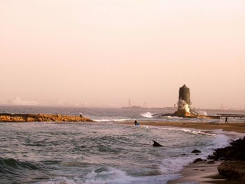 Scenic view of sea against clear sky during sunset