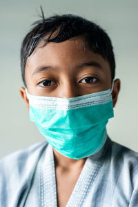 Close-up portrait of man covering face