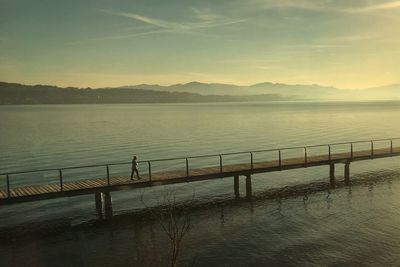 Scenic view of lake against sky at sunset