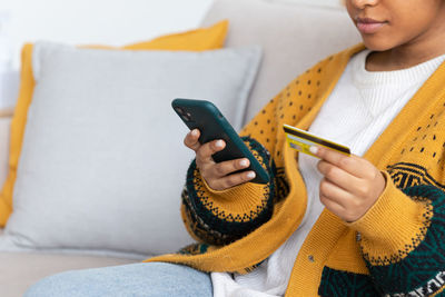 Midsection of woman using mobile phone