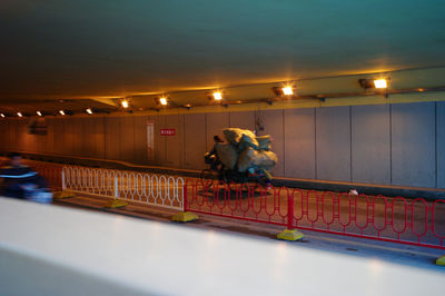 Men standing on illuminated bridge