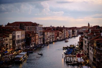 High angle view of canal grande in venice amidst buildings in city