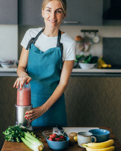 Mid adult man preparing food on table at home